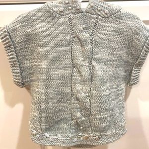 Light grey hand knitted sweater, hoodie. Decorated with hand sewn decorations.